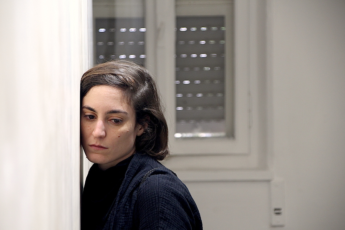 a woman listening to the sound installation 'The other Side' by Meital Covo